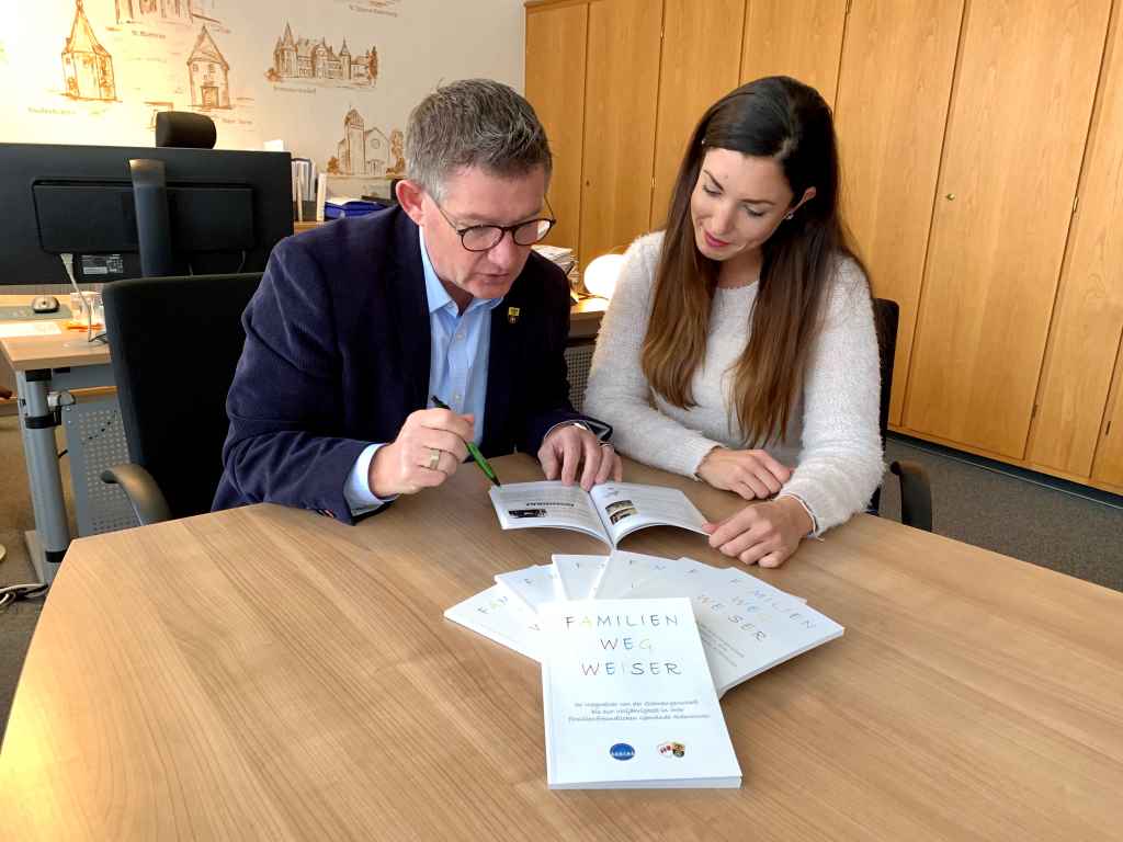 Zufrieden mit dem Ergebnis intensiver Arbeit: Abteilungsleiterin Stephanie Oellers und Bürgermeister Ralf Claßen blättern durch den Familienwegweiser.